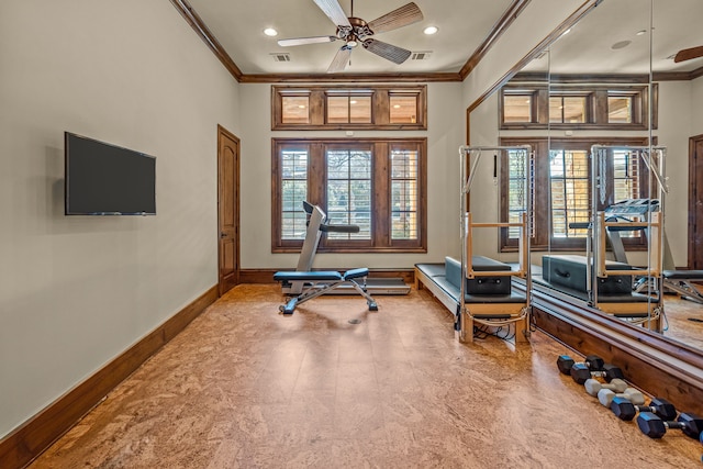 workout room featuring ornamental molding and ceiling fan