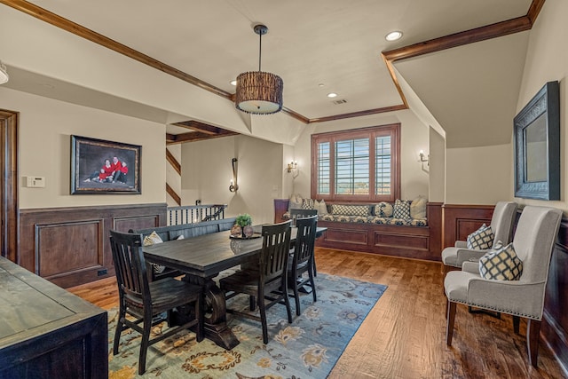 dining area with hardwood / wood-style flooring and crown molding