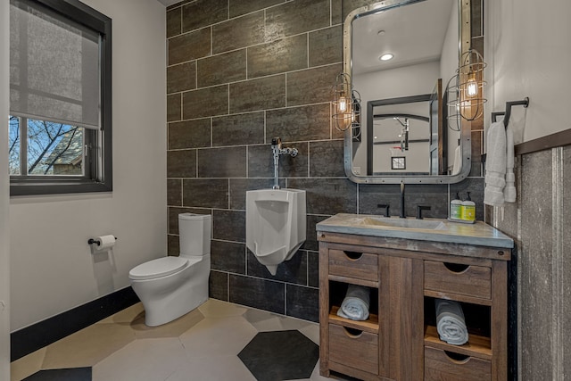 bathroom with vanity, tile walls, tile patterned floors, and toilet