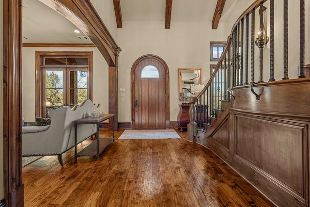 entrance foyer featuring hardwood / wood-style floors and beamed ceiling