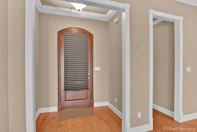 foyer with crown molding and hardwood / wood-style flooring