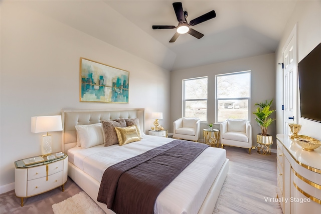 bedroom with lofted ceiling, ceiling fan, and light wood-type flooring