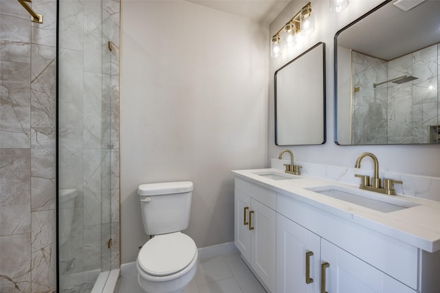 bathroom featuring a shower with door, vanity, tile patterned flooring, and toilet