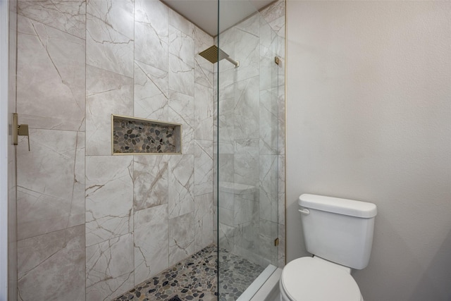 bathroom with tiled shower and toilet