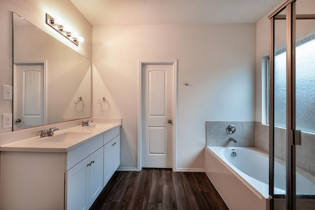 bathroom with vanity, wood-type flooring, and a bathing tub