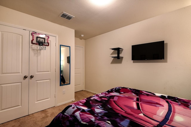 bedroom with carpet floors and a closet