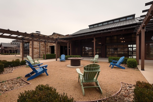 view of patio / terrace featuring a pergola and a fire pit