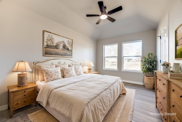 bedroom with lofted ceiling, hardwood / wood-style flooring, and ceiling fan