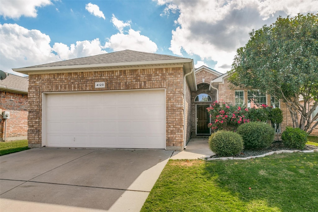 view of front of property with a garage and a front yard