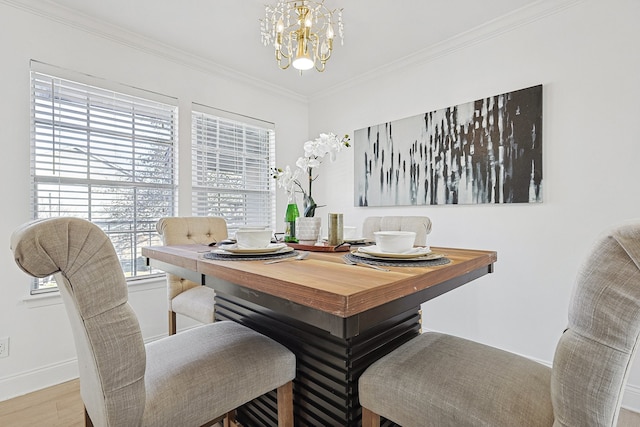 dining room featuring crown molding, light wood-type flooring, and an inviting chandelier