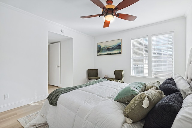 bedroom with crown molding, light hardwood / wood-style flooring, and ceiling fan