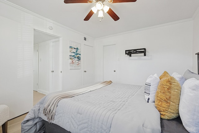 bedroom featuring ornamental molding, ceiling fan, and light wood-type flooring