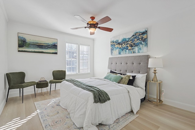 bedroom featuring ornamental molding, ceiling fan, and light hardwood / wood-style floors