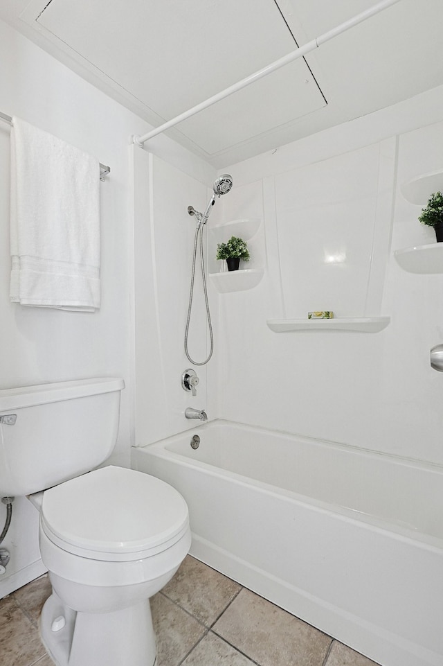 bathroom with tile patterned flooring, shower / bathtub combination, and toilet