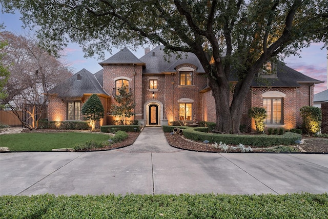 french provincial home with a yard