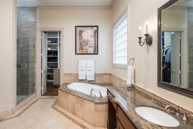 bathroom with shower with separate bathtub, ornamental molding, and vanity