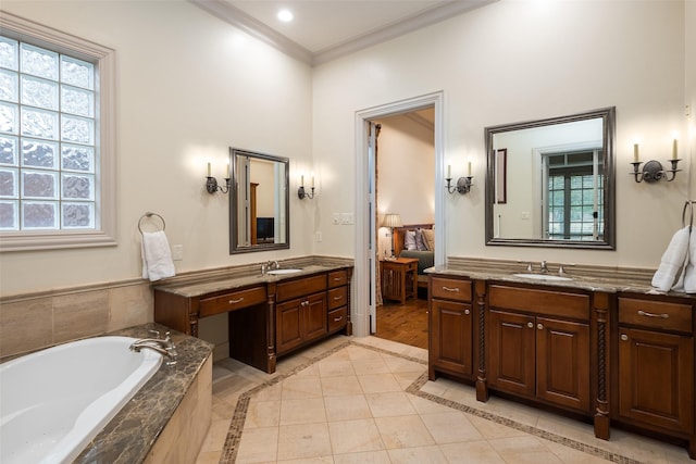 bathroom featuring vanity, a relaxing tiled tub, tile patterned floors, and crown molding