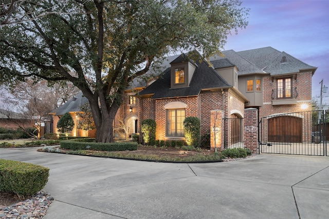 french provincial home featuring a garage