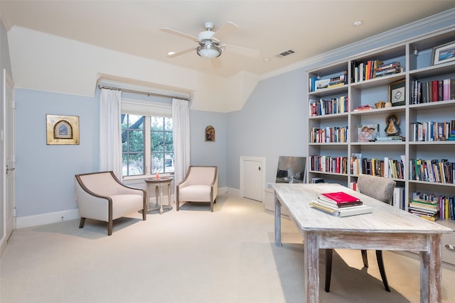 carpeted office with crown molding, lofted ceiling, and ceiling fan