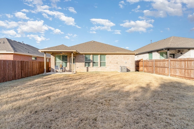 back of property featuring ceiling fan, central AC unit, a patio, and a lawn