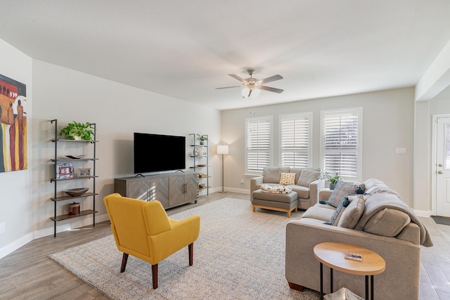 living room with ceiling fan and light hardwood / wood-style floors