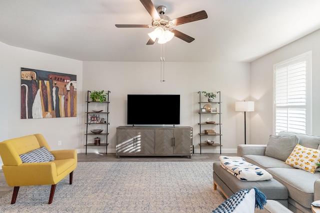 living room with wood-type flooring and ceiling fan