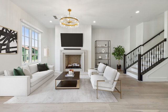 living room featuring light hardwood / wood-style floors and a chandelier