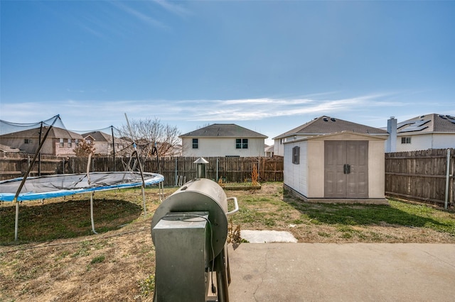 view of yard with a storage unit and a trampoline