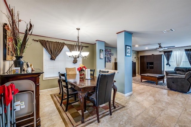 tiled dining area with ceiling fan with notable chandelier