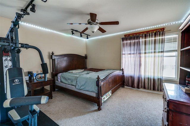 bedroom with ceiling fan, rail lighting, and light carpet