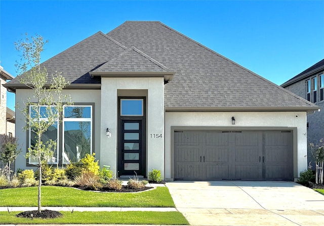 1154 20th St, Northlake, TX 76226 - view of front of house featuring a front yard, stucco siding, a shingled roof, concrete driveway, and an attached garage