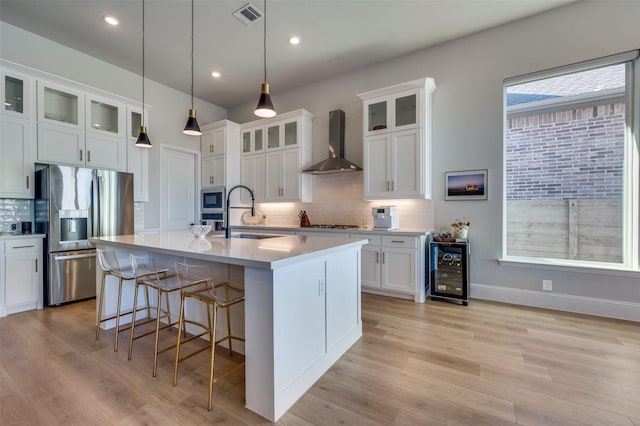 1154 20th St, Northlake, TX 76226 - kitchen featuring visible vents, beverage cooler, wall chimney exhaust hood, a sink, and appliances with stainless steel finishes