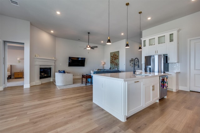 1154 20th St, Northlake, TX 76226 - kitchen with a sink, light wood-style floors, open floor plan, and visible vents