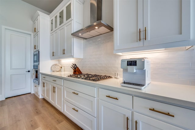 1154 20th St, Northlake, TX 76226 - kitchen with glass insert cabinets, light countertops, wall chimney exhaust hood, white cabinetry, and appliances with stainless steel finishes