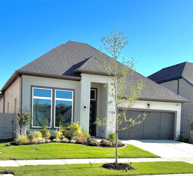 1154 20th St, Northlake, TX 76226 - view of front of house featuring a front lawn, stucco siding, a shingled roof, concrete driveway, and an attached garage