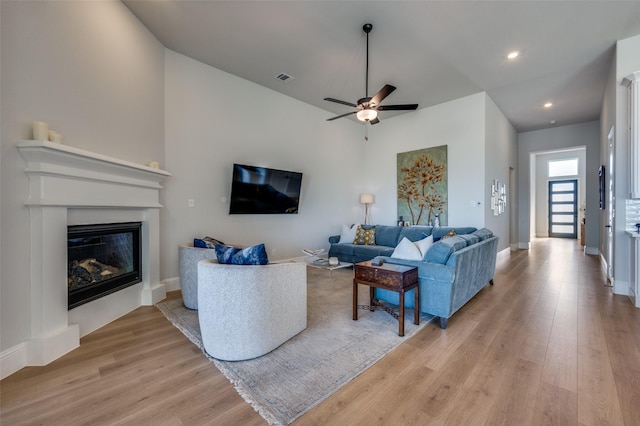 1154 20th St, Northlake, TX 76226 - living room with visible vents, a glass covered fireplace, light wood-type flooring, recessed lighting, and a ceiling fan