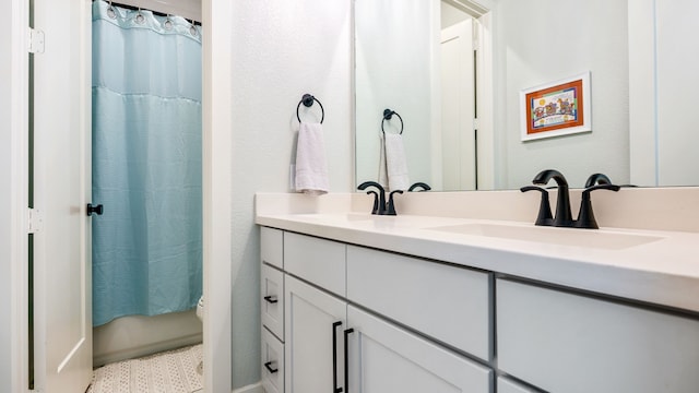 bathroom featuring vanity and curtained shower