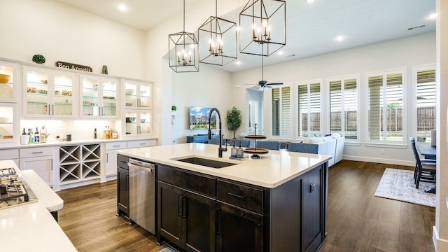 kitchen with pendant lighting, sink, white cabinets, a center island with sink, and dark hardwood / wood-style flooring