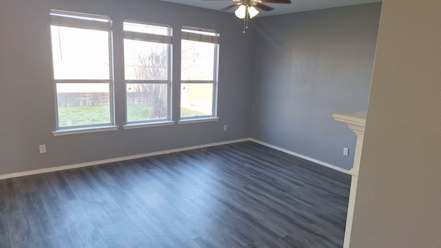 empty room with dark hardwood / wood-style floors and ceiling fan