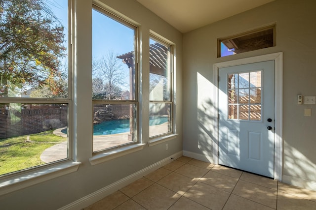 doorway to outside featuring plenty of natural light and light tile patterned flooring