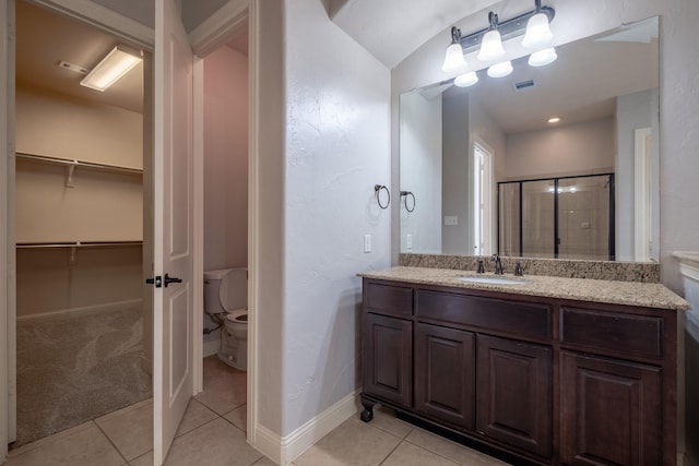 bathroom with vanity, an enclosed shower, tile patterned floors, and toilet