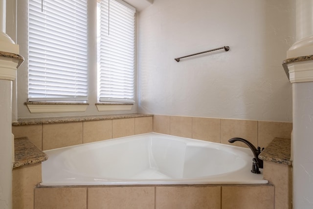 bathroom with tiled tub