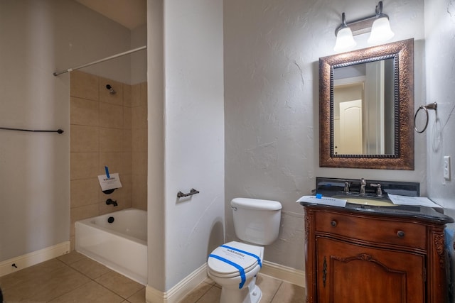 full bathroom with tile patterned flooring, vanity, tiled shower / bath, and toilet