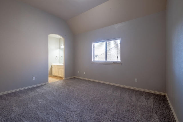 spare room with lofted ceiling and light carpet