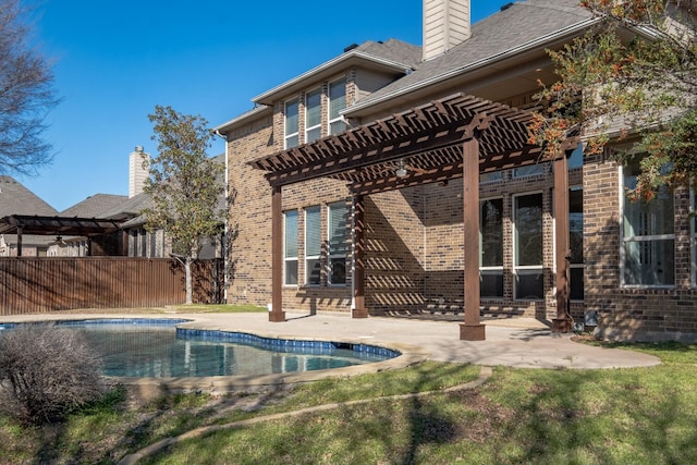 back of house featuring a fenced in pool, a pergola, and a patio area