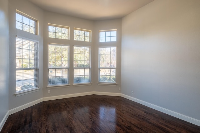 unfurnished room with dark hardwood / wood-style floors