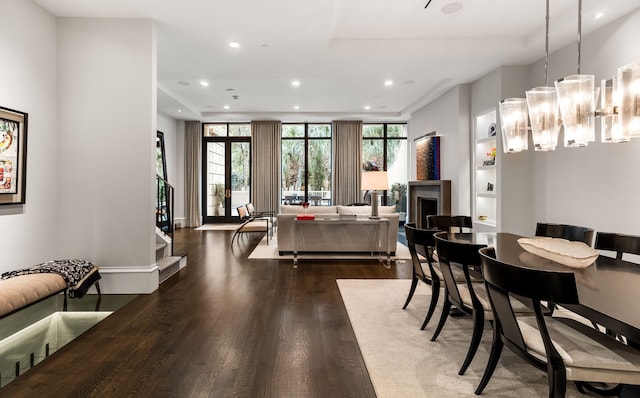 dining room with dark hardwood / wood-style floors and an inviting chandelier