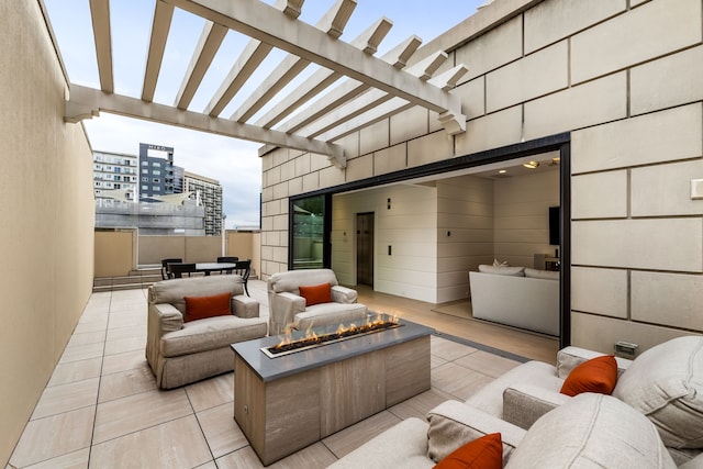 view of patio / terrace with a pergola and an outdoor living space with a fire pit