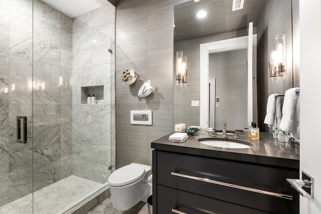 bathroom featuring vanity, toilet, and a shower with shower door