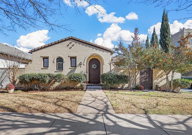 mediterranean / spanish home with a front lawn